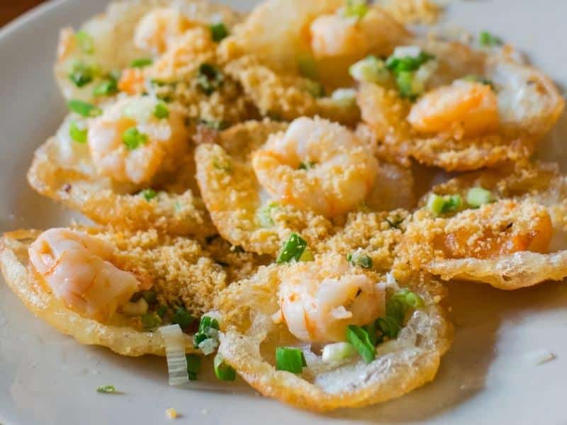 Banh khot, or Vietnamese savory pancakes, with a shrimp in each one and peanut powder on top 