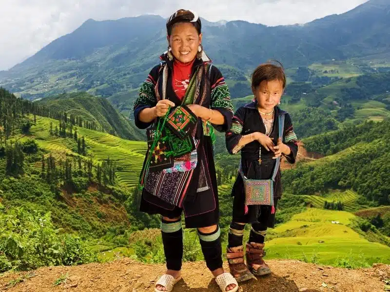 A hill tribe woman and child wearing their traditional clothing in Vietnam