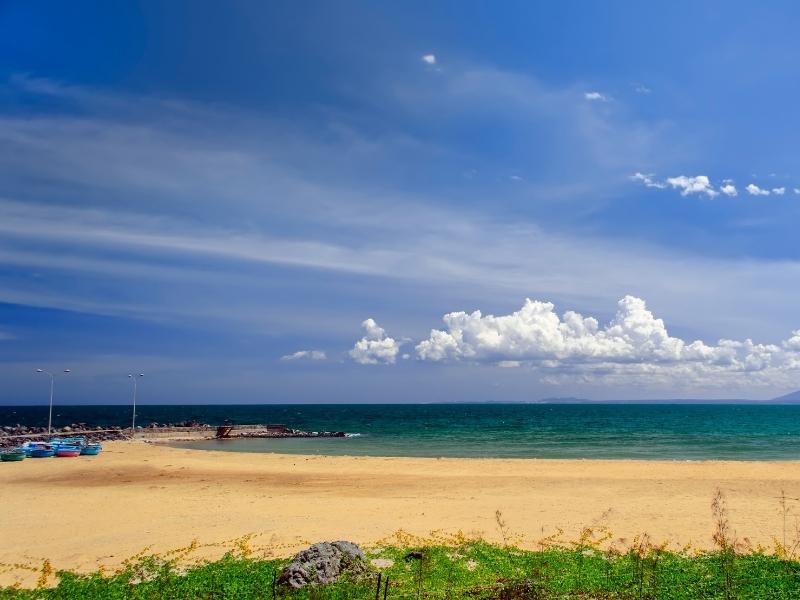 A beach in Mui Ne, Vietnam with no people on it and a few boats on the side