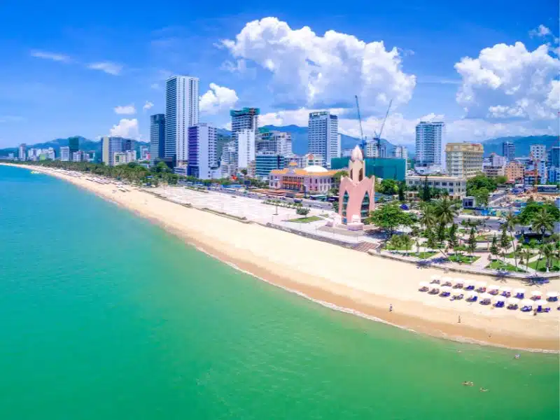 An expansive aerial view of Nha Trang beach with buildings fronting it